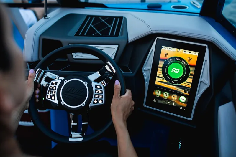 Slide: The Image of Manufacturer Provided Image: 2020 Tigé 23ZX boat dashboard with touchscreen controls and steering wheel. - 17