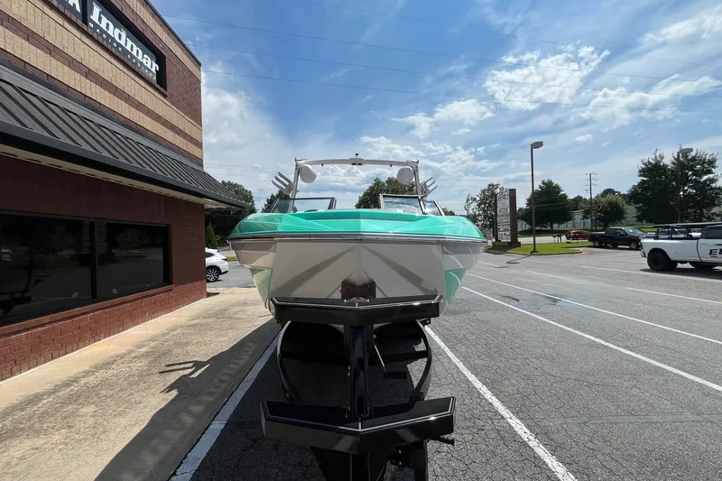 Slide: The Image of 2020 Tigé 23ZX boat on trailer outside Indmar building under a sunny sky. - 2