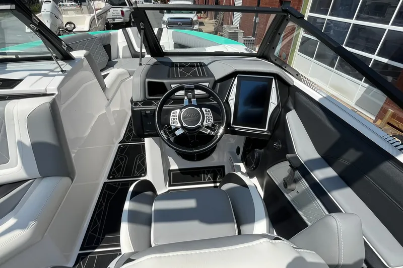 Slide: The Image of 2020 Tigé 23ZX boat interior with modern dashboard and steering wheel. - 8