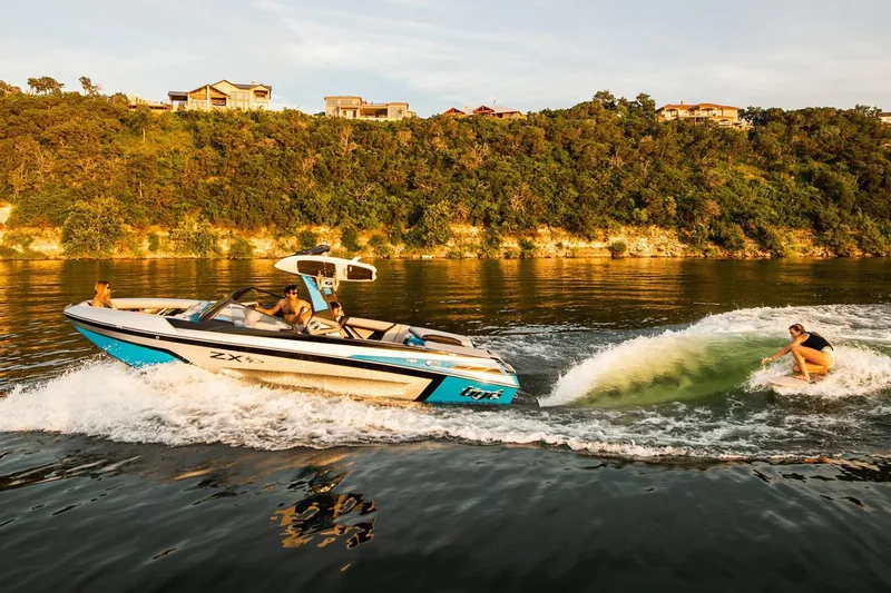 Slide: The Image of Manufacturer Provided Image: 2020 Tigé 23ZX boat creating waves for wakeboarding on a scenic lake. - 16
