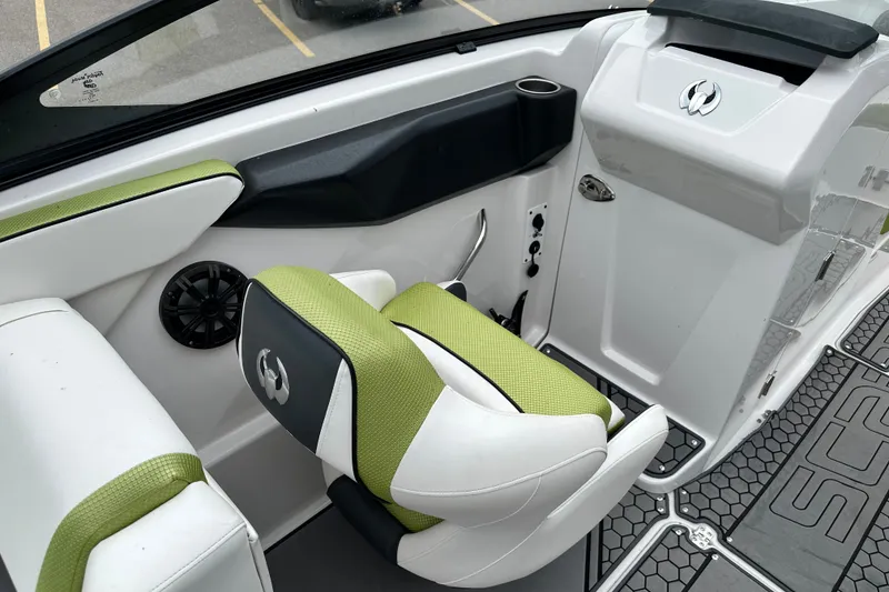 Slide: The Image of Interior of 2017 Scarab 255 boat with green and white seating, speaker, and modern design. - 8