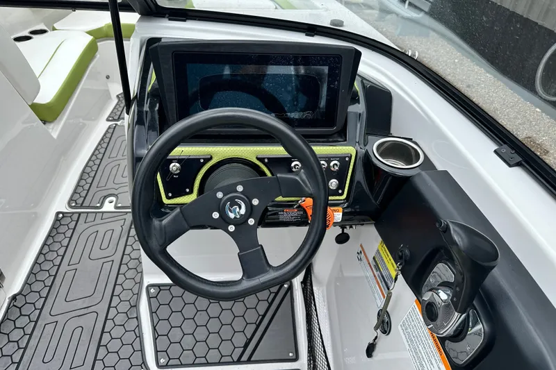 Slide: The Image of Steering console of a 2017 Scarab 255 boat with modern controls and cup holder. - 10