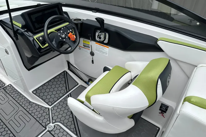 Slide: The Image of Interior of a 2017 Scarab 255 boat with green and white seating. - 9