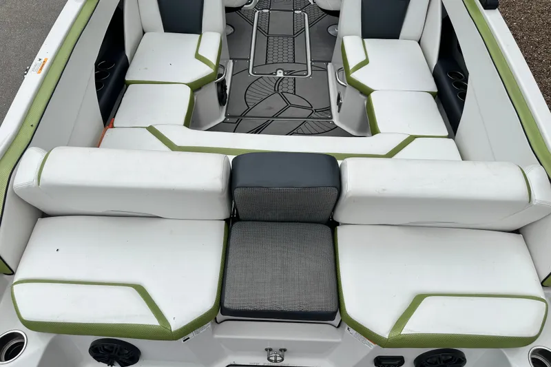 Slide: The Image of Interior seating of a 2017 Scarab 255 boat with white and green upholstery. - 6