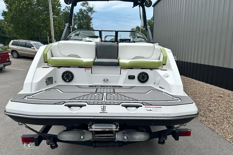 Slide: The Image of 2017 Scarab 255 boat rear view with seating and speakers, parked outdoors. - 5