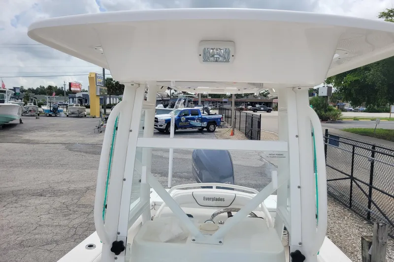 Slide: The Image of 2010 Everglades 243 Center Console boat at a dealership, showcasing its sturdy design. - 14