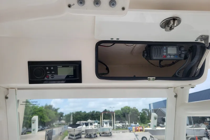 Slide: The Image of 2010 Everglades 243 Center Console boat dashboard with radio and communication equipment. - 17