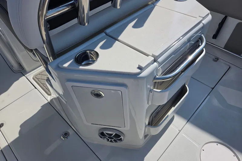 Slide: The Image of 2026 Finseeker 220 CC boat interior with storage compartments and cup holder. - 15