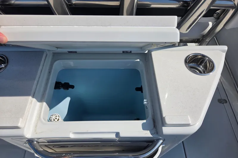 Slide: The Image of Open storage compartment on 2026 Finseeker 220 CC boat with cup holder. - 13