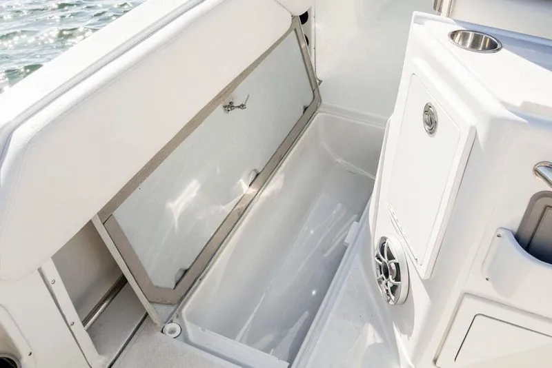 Slide: The Image of Manufacturer Provided Image: 2026 Finseeker 220 CC boat interior with storage compartment and cup holder. - 10