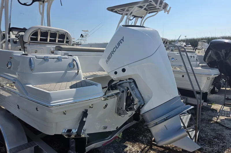 Slide: The Image of 2026 Finseeker 220 CC boat with Mercury outboard engine, docked on a trailer. - 25