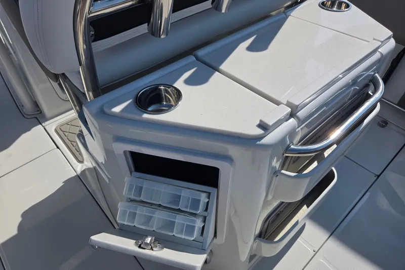 Slide: The Image of 2026 Finseeker 220 CC boat interior with storage compartments and cup holders. - 16