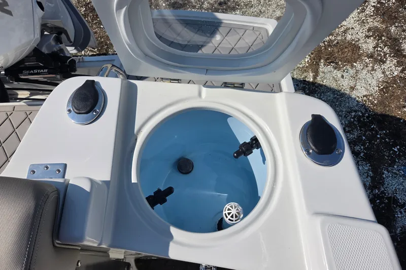 Slide: The Image of Livewell on 2026 Finseeker 220 CC boat, featuring open lid and plumbing fixtures. - 18