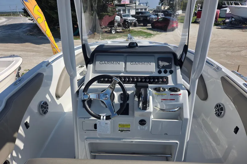 Slide: The Image of 2026 Finseeker 220 CC boat dashboard with Garmin navigation system and steering wheel. - 11