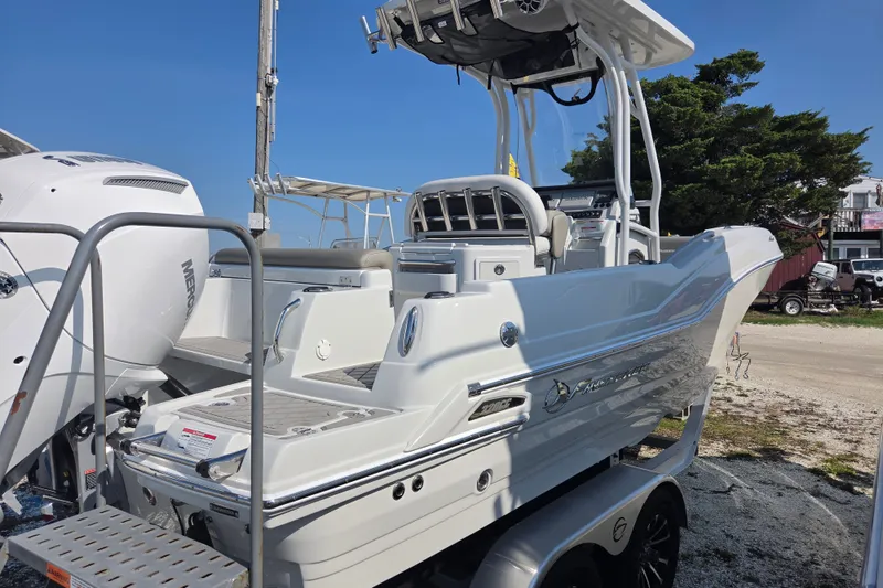Slide: The Image of 2026 Finseeker 220 CC boat with sleek design and powerful engine, parked outdoors. - 24