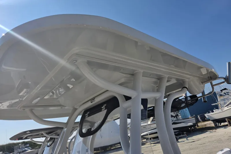 Slide: The Image of 2026 Finseeker 220 CC boat's T-top structure under clear blue sky. - 20