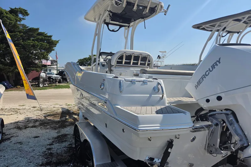 Slide: The Image of 2026 Finseeker 220 CC boat with Mercury engine, displayed outdoors on a sunny day. - 26