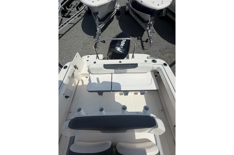 Slide: The Image of 2021 Robalo R222 Center Console boat interior with seating and motor view. - 8