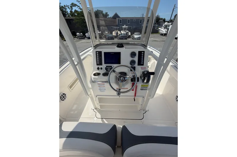 Slide: The Image of 2021 Robalo R222 Center Console boat interior with steering wheel and control panel. - 11