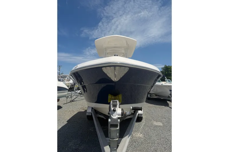 Slide: The Image of 2021 Robalo R222 Center Console boat on trailer under clear blue sky. - 1