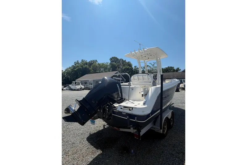 Slide: The Image of 2021 Robalo R222 Center Console boat with outboard motor on trailer. - 4