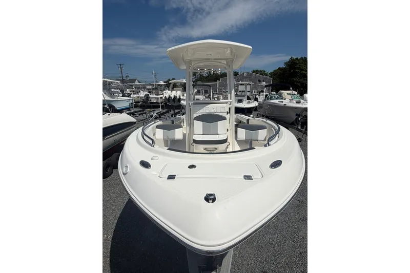 Slide: The Image of 2021 Robalo R222 Center Console boat with sleek design, docked under a clear sky. - 2