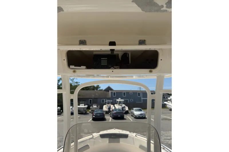 Slide: The Image of 2021 Robalo R222 Center Console boat with Simrad electronics, parked in a marina. - 12