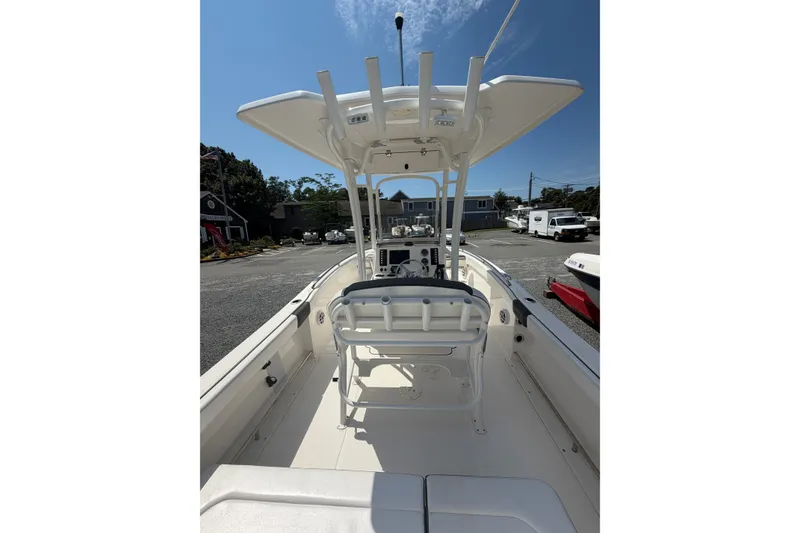 Slide: The Image of 2021 Robalo R222 Center Console boat with T-top and seating, parked outdoors. - 10