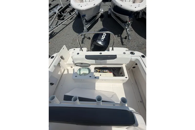 Slide: The Image of 2021 Robalo R222 Center Console boat interior with storage and seating. - 9