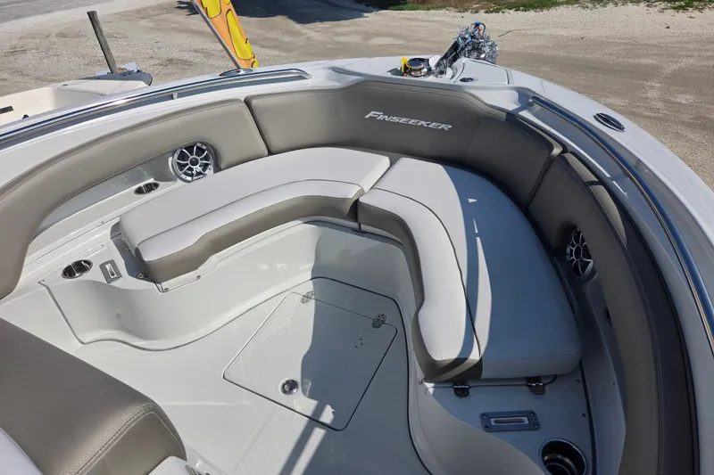 Slide: The Image of 2026 Finseeker 210 CC boat interior with cushioned seating and cup holders. - 13