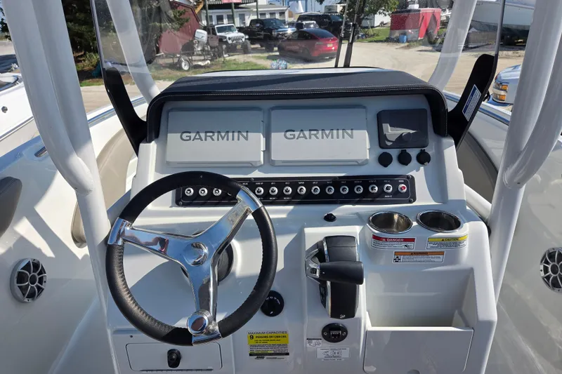 Slide: The Image of 2026 Finseeker 210 CC boat dashboard with Garmin displays and steering wheel. - 17