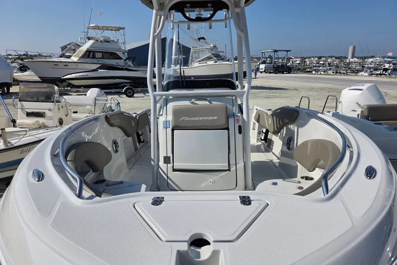 Slide: The Image of 2026 Finseeker 210 CC boat at marina, showcasing sleek design and spacious seating. - 14