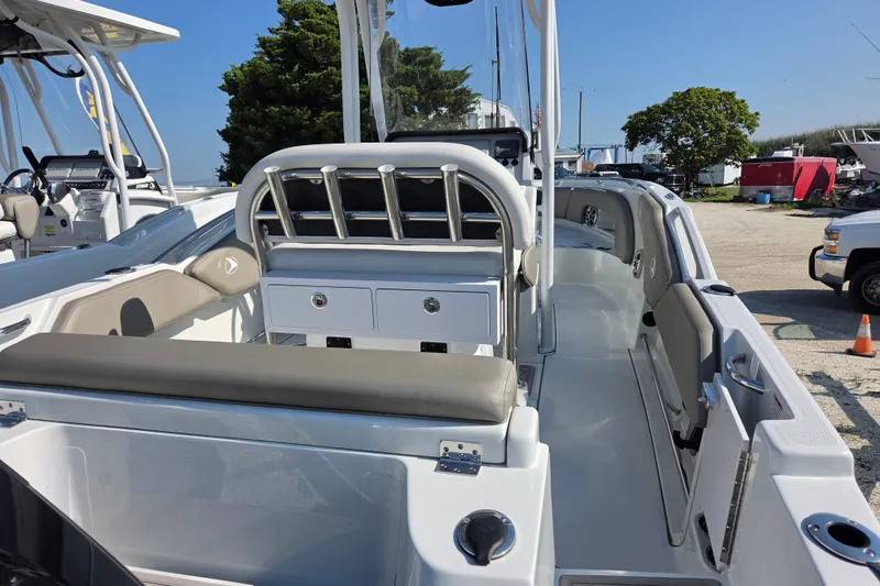 Slide: The Image of 2026 Finseeker 210 CC boat interior with seating and storage, docked outdoors. - 16