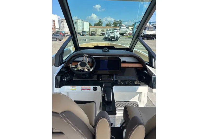 Slide: The Image of Interior view of 2027 Monterey Elite 25 OB boat cockpit with steering wheel and dashboard. - 4