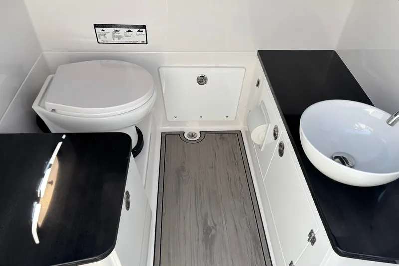 Slide: The Image of Modern bathroom interior of 2027 Monterey Elite 25 OB boat, featuring sleek sink and toilet. - 8