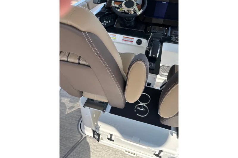 Slide: The Image of Interior view of 2027 Monterey Elite 25 OB boat cockpit with steering wheel and seating. - 7