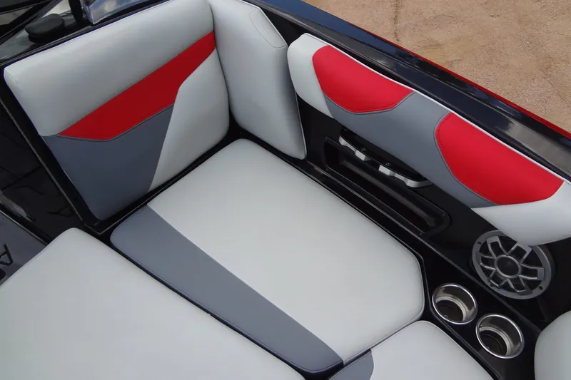 Slide: The Image of 2020 Axis A22 boat interior with red, gray, and white seating, featuring cup holders and speaker. - 13