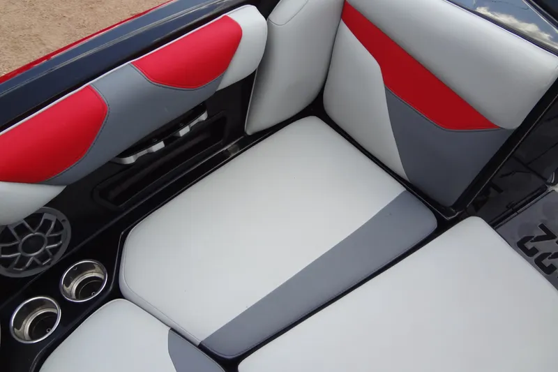 Slide: The Image of 2020 Axis A22 boat interior with red, gray, and white seating and cup holders. - 14