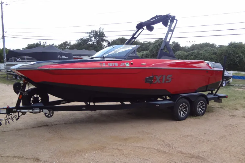 Slide: The Image of Red 2020 Axis A22 boat on trailer, parked outdoors. - 6