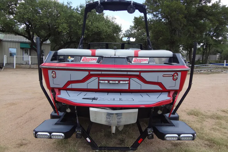 Slide: The Image of 2020 Axis A22 boat rear view with custom graphics and wakeboard tower. - 3