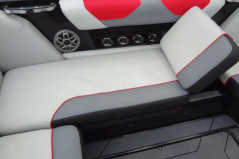 Slide: The Image of 2020 Axis A22 boat interior with red and gray seating and speaker system. - 18