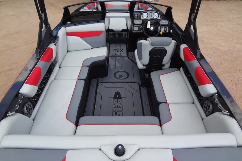 Slide: The Image of 2020 Axis A22 boat interior with gray and red seating, modern dashboard, and spacious layout. - 11