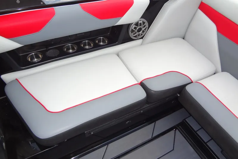 Slide: The Image of 2020 Axis A22 boat interior with red, gray, and white seating and cup holders. - 23