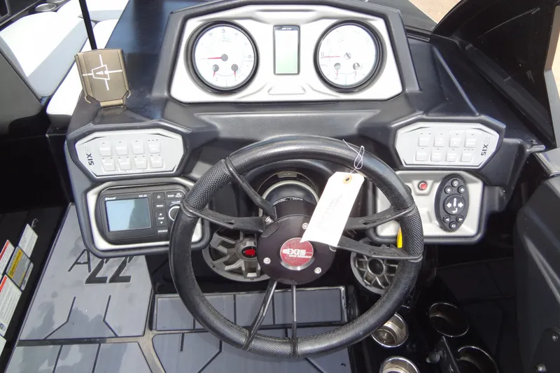 Slide: The Image of 2020 Axis A22 boat dashboard with steering wheel, gauges, and control panels. - 25