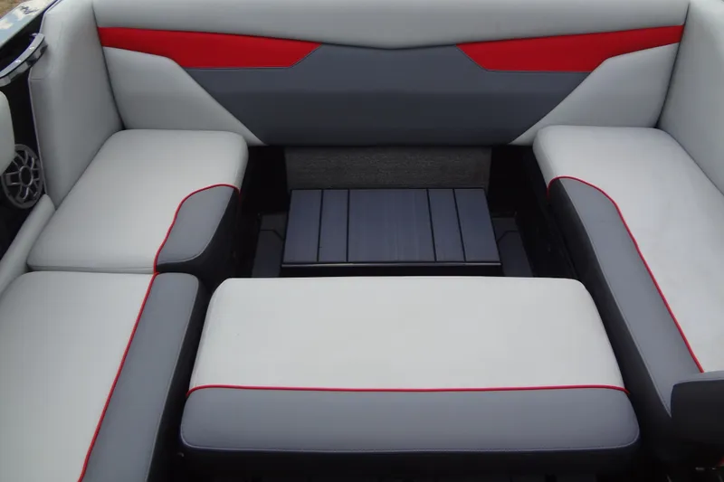 Slide: The Image of 2020 Axis A22 boat interior with gray and red cushioned seating. - 20