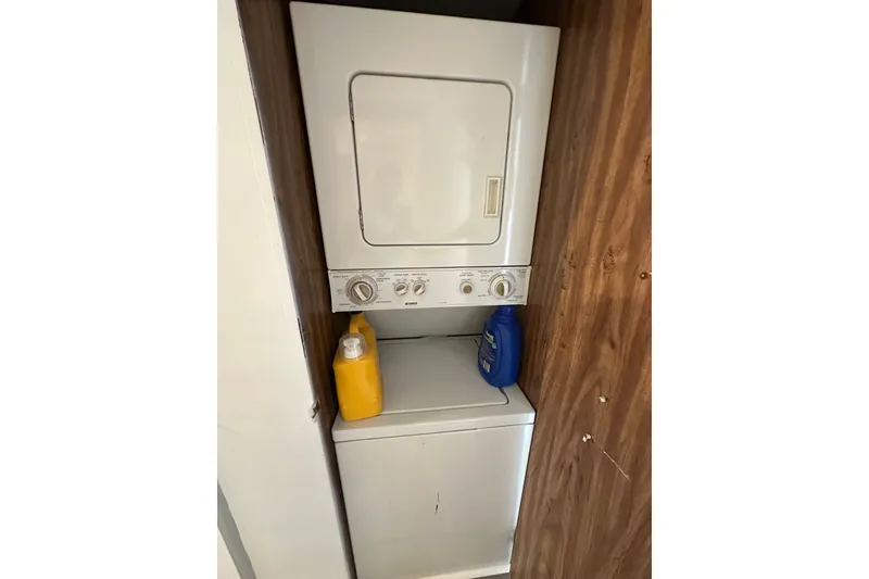 Slide: The Image of Stacked washer and dryer in a 1980 Lazy Days 14x60 model, with detergent bottles. - 16