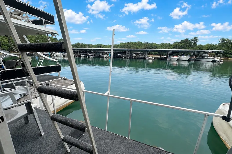 Slide: The Image of Houseboat view from Lazy Days 14x60, 1980 model, overlooking serene marina and docked boats. - 17