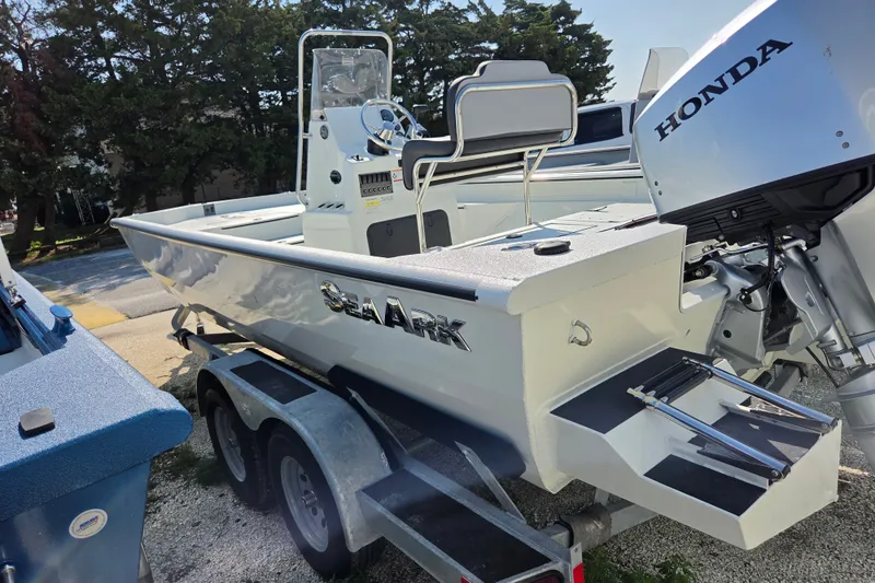 The Image of 2026 SeaArk Bay Runner 210 boat with Honda outboard motor on trailer. - 0