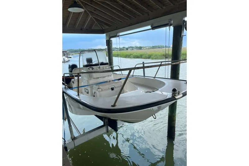 Slide: The Image of 2016 Boston Whaler 170 Montauk boat suspended in a covered dock area. - 0