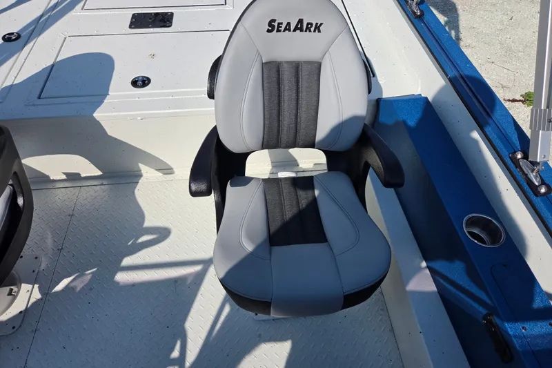 Slide: The Image of 2026 SeaArk Big Easy boat seat, gray and black design, on a textured deck. - 4